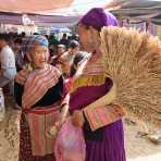 Two women from the Flower Hmong people ethnic minority group, wearing traditional clothes, chatting at the Can Cau market, Lao Cai province, Viet Nam, Indonesia, South East Asia