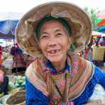 An old woman from the Flower Hmong people ethnic minority wearing her bamboo hat and showing a big smile, Bac Ha market, Lao Cai Province, Viet Nam, Indochina, South East Asia