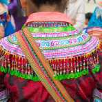 Particular from the costume of the Flower Hmong people ethnic minority, Bac Ha market, Lao Cai province. Viet Nam, Indochina, South East Asia.