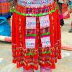 Woman from the Flower Hmong people ethnic minority wearing a colorful and beautiful traditional skirt, Bac Ha market, Lao Cai province. Viet Nam, Indochina, South East Asia.