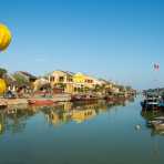 Traditional fishing boats and view of the old town, Thu Bon river, Hoi An, Quang Nam province. Viet Nam, Indochina, South east Asia.