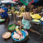 Vendor with her goods in baskets carried on bamboo shoulder pole, Huáº¿, Thua Thien-Hue province. Viet Nam, Indochina, South east Asia.