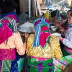Women from the Balck Hmong people ethnic minority group havng lunch at busy market in Dong Van, Ha Giang Province, Viet Nam, Indochina, South East Asia