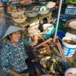 Woman showing a fresh crab at the busy market in Hoi An, Quang Nam Province, Viet Nam, Indochina, South East Asia