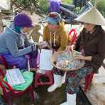 Counting millions of Vietnam Dong at the wholesale fish market in Thanh Ha, Quang Nam Province, Viet Nam, Indochina, South East Asia.