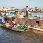 A woman catering breakfast early morning at the Cai Rang vegetable floating market in the Mekong River Delta, Can Tho, Hau Giang Province, Viet Nam, Indochina, South East Asia.