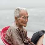 A very old man, resting on a chair in Ho Chi Minh City (Saigon). Viet Nam, Indochina, South East Asia.