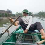 Unusual practice of rowing with feet on the Ngo Dong river, Tam Coc - Bich Dong, Ninh Binh Province. Ninh Binh Province. Viet Nam, Indochina, South East Asia.