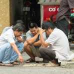 Hard work,  men playing Chinese chess on the street of Ho Chi Minh City (Saigon). Viet Nam, Indochina, South East Asia.