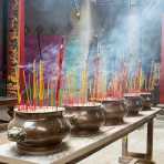 Incense burning sticks worshipping Buddha. Ho Chi Minh City (Saigon), Viet Nam, Indochina, South East Asia.