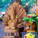 Wood carved Buddhist statue of Asura, a deity with three faces and many arms at To Dinh Van Duc pagoda, Hoi An, Quang Nam province, Viet Nam, Indochina, South East Asia