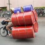 A small motorbike fully loaded with 50 gallons drums, hopefully empty! Ho Chi Minh City (Saigon), Viet Nam, Indochina, South East Asia.