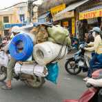 A delivery man with his motorbike really fully loaded of any sort of merchandise. Ho Chi Minh City (Saigon), Viet Nam, Indochina, South East Asia.