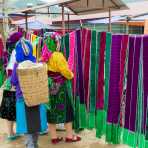 Women from the Black Hmong people ethnic minority at the Don Van market buying traditional clothes. Ha Giang Province, Viet Nam, Indochina, South East Asia