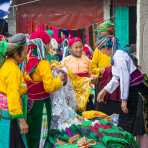 Women from the Black Hmong people ethnic minority group, buying traditional clothes at busy market in Dong Van, Ha Giang Province, Viet Nam, Indochina, South East Asia